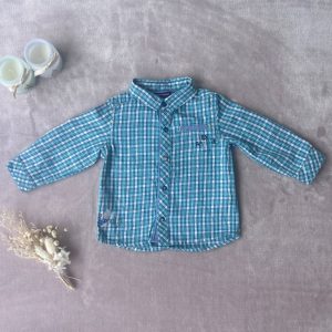 Chemise à carreaux bleue garçon d'occasion 12 mois.