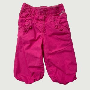 Pantalon bébé fille fuchsia coupe ballon avec taille élastiquée, poches décorées et détails nœuds. Orchestra, 6 mois d'occasion
