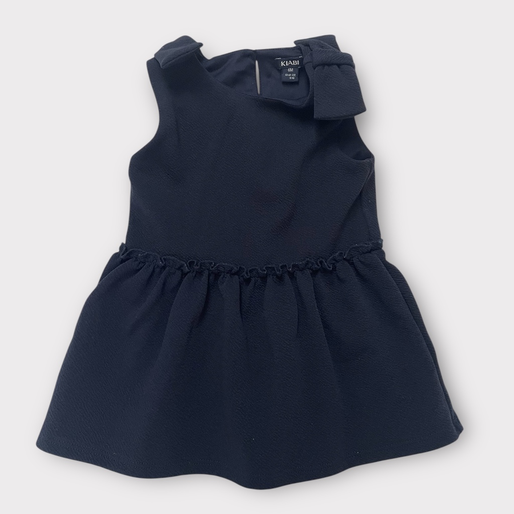 Robe bleu marine sans manches avec volant et nœud à l'épaule. Chic et confortable. Seconde main.