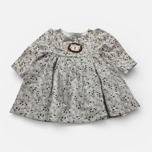 Robe bébé manches longues en molleton crème avec des motifs répétés marrons foncés. Seconde main.