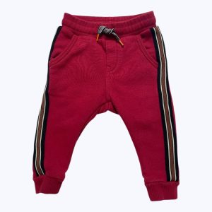 Jogging bébé molleton rouge avec des bandes sur le côté, élastiqué à la taille et cordon. Seconde main.