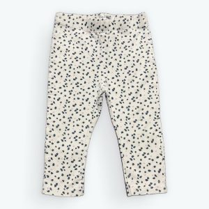 Legging bébé blanc avec des petits motifs répétés colorés. Seconde main.