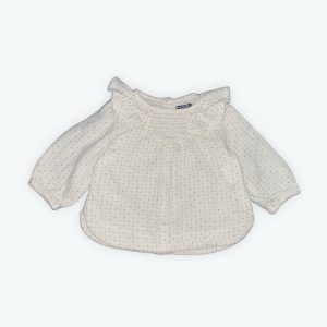 Blouse bébé manches longues crème motifs bleu marine encolure volantée smocks devant. Seconde main.
