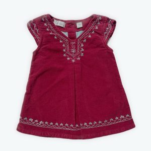 Robe bébé manches courtes en velours rouge, un pli devant brodée de motifs arabesques ouverture centrale dos. Seconde main.